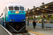 Passengers Board Commuter Train At Railway Station Passengers Board Commuter Train At Railway Station