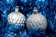Silver glass balls on blue garland background