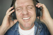 Man with Eyes Shut Wearing Headphones Enjoying His Music Man with Eyes Shut Wearing Headphones Enjoying His Music