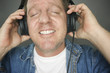 Man with Eyes Shut, Headphones Enjoying Music - Grey Background. Man with Eyes Shut, Headphones Enjoying Music - Grey Background.