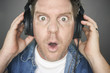 Shocked Man Wearing Headphones against a grey background. Shocked Man Wearing Headphones against a grey background.
