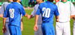 Soccer competition. Blue and white uniform. Sun weather.