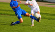 Soccer competition. Blue and white uniform. Sun weather.