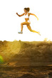 A woman running down a path at the beach A woman running down a path at the beach