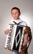 Young boy playing a 48 base accordion