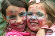 Two beautiful young girls with faces painted for carnival parade