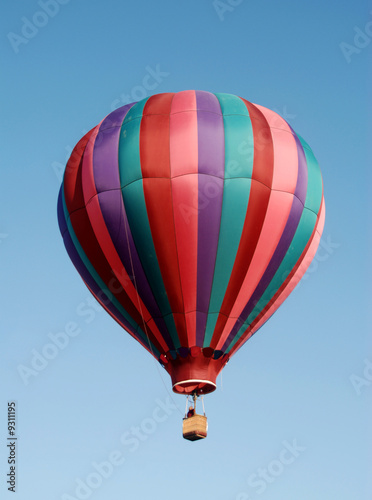 Photo: Colorful hot air balloon floating in blue sky Colorful hot air balloon floating in blue sky