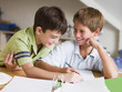 Two Young Boys Doing Their Homework Together