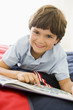 Photo: Young Boy Lying Down On His Bed Reading A Book Young Boy Lying Down On His Bed Reading A Book