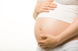 Close-up of pregnant woman’s belly with her hand on it