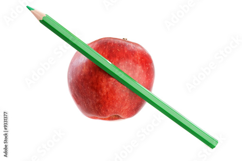 Photo: Apple red with green pen on a white background Apple red with green pen on a white background
