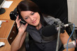 A radio DJ is listening to radio broadcasting