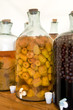 Apple and cherry liquors in bottles on the table