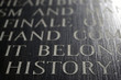 A closeup of the word HISTORY engraved on a war memorial.