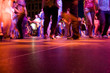 The dance floor with people dancing under the colorful lights. The dance floor with people dancing under the colorful lights.