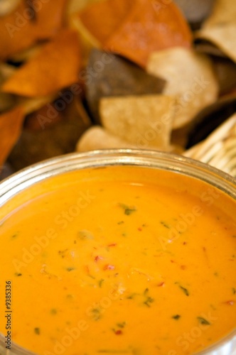 Photo: An image of colorful tortilla chips with queso An image of colorful tortilla chips with queso