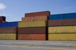 Stacks of colored cargo containers in a major port.