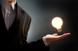 a man pointing to the illuminated bulb