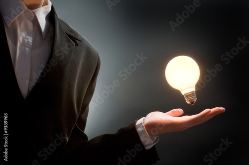 Photo: a man pointing to the illuminated bulb a man pointing to the illuminated bulb