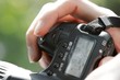 Hand holding a digital SLR camera