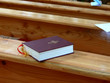 holy bible on an empty church bench holy bible on an empty church bench