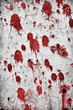 Red splatter on a grungy rock wall.