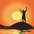 A silhouette of a man atop a mountain with his arms raised up