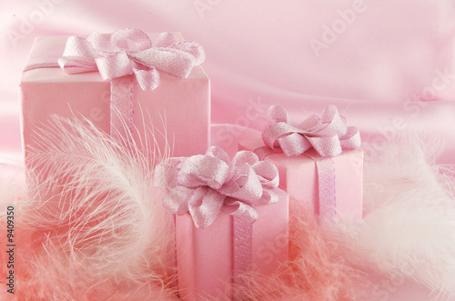 Photo : Three pink boxes wiht gift on the pink background Three pink boxes wiht gift on the pink background