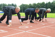 Group of businessmen are ready for the start of the run.