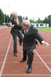 Two businessmen working as a team during a run.