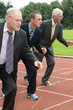 Group of businessmen are ready for the start of the run.