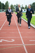 Group of businessmen running on a track. How's gonna win?