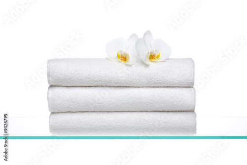 Photo: Fresh Towels with white Orchids on glass Fresh Towels with white Orchids on glass