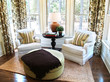 Two comfortable overstuffed chairs in a luxury sunroom