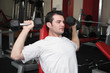 Sportsman with weight at gym