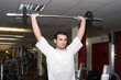 Sportsman with weight at gym