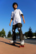 Boy on a Skateboard Against Blue Sky Looking in the Sun Boy on a Skateboard Against Blue Sky Looking in the Sun
