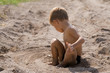 little boy sitting on sand