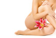 Female legs with pink lily isolated on white background Female legs with pink lily isolated on white background