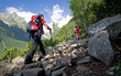 Nordic walking in mountains. Young female.