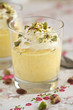 Delicious mango mousse with whipped cream and pistachio nuts Delicious mango mousse with whipped cream and pistachio nuts
