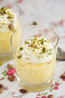Delicious mango mousse with whipped cream and pistachio nuts Delicious mango mousse with whipped cream and pistachio nuts