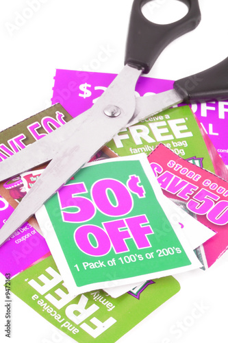 Photo: clipping coupons to save money at the grocery store clipping coupons to save money at the grocery store
