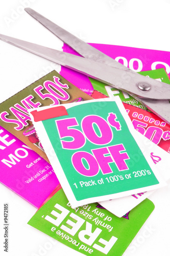 Photo: clipping coupons to save money at the grocery store clipping coupons to save money at the grocery store