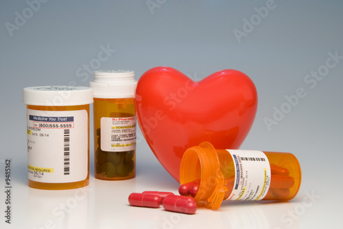A heart and bottles of prescription medication.