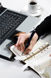 Above view of female hand writing in notepad