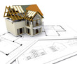 House under construction on blueprints