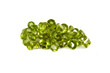 A groupn of mixed faceted peridots on a white background