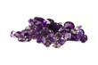 a grouping of mixed faceted amethysts on a white background