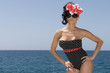 Photo: sexy pin up woman near the sea with blue day background sexy pin up woman near the sea with blue day background